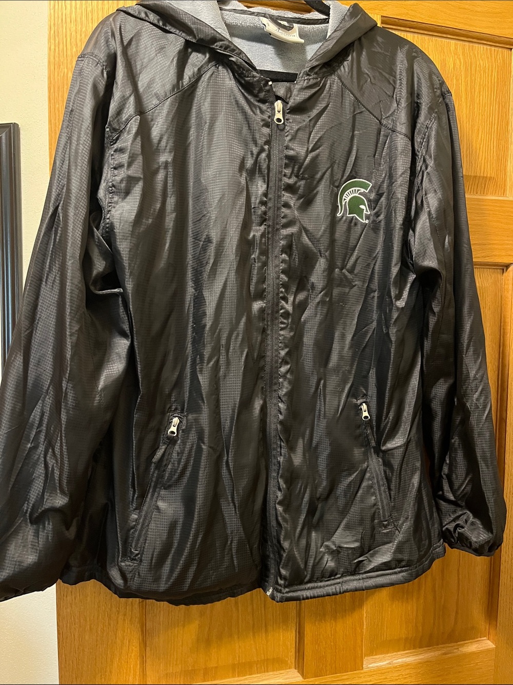 Women’s Black Hooded Windbreaker Jacket with Michigan State Logo